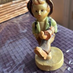 Boy Figurine Carrying An Umbrella Under His Arm And A Bucket On The Back 