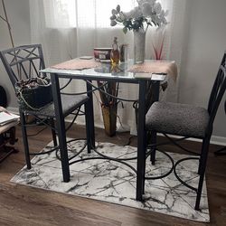 Two seat, dining table, and chairs with glass top.