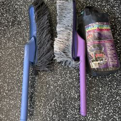 This is a California Car Duster, specifically a model with a purple plastic handle and cotton strands designed for scratch-free vehicle cleaning. 