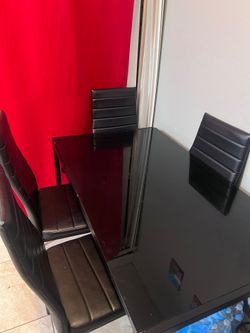 Glass kitchen table with leather chairs