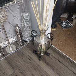 Glass and metal vase with sticks