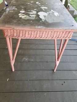 Antique pink wicker table