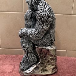 Abominable snowman sitting on a block of ice