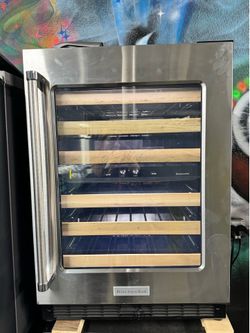 Kitchen aid 24” undercounter wine cellar with glass door and wood-front racks