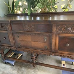carved Jacobean revival style dark wood sideboard.