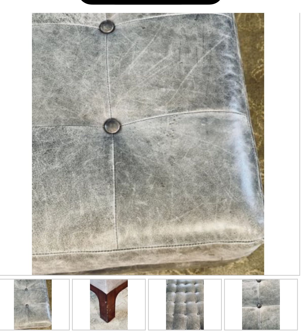 Grey Leather Button Tufted Ottoman On A Dark Wood Base