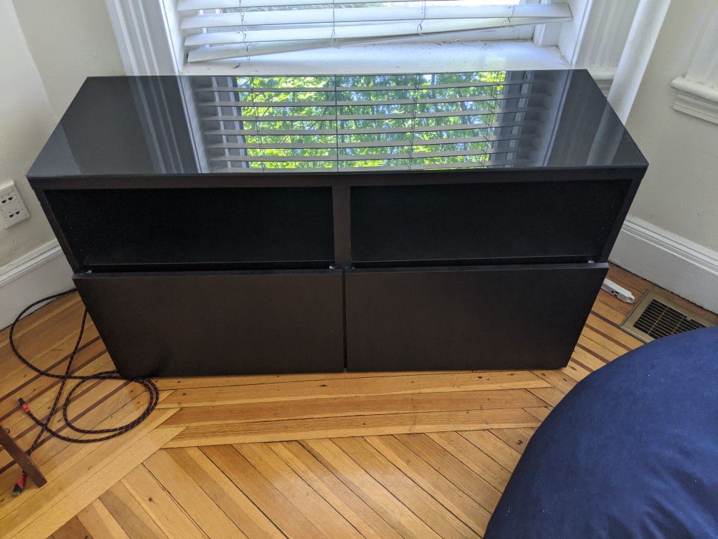 Dark wooden TV stand with glass top