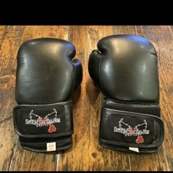 I Love Kickboxing (ILKB) black boxing gloves, manufactured by the company Century. They are typically sold as 12-ounce or 14-ounce gloves for Unisex