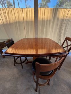 Beautiful wooden dining table with 2 matching chairs for sale.