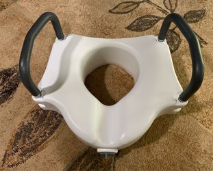 Drive Medical elevated toilet seat, model RTL12027RA, featuring removable padded arms for added stability.