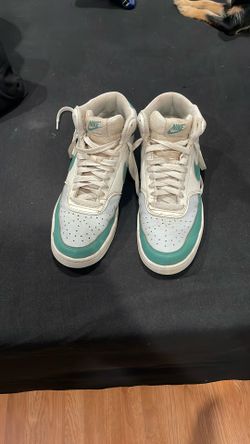 Green and white Nike high tops