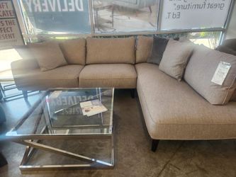 Modern Sectional in lovely textured polyester Taupe fabric.  Chaise on Right when facing