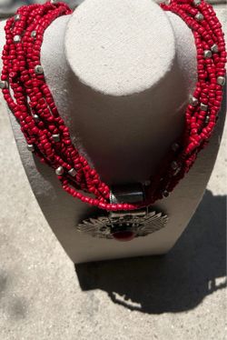 Multi strand red bead Boho necklace with a large silver-tone concho pendant