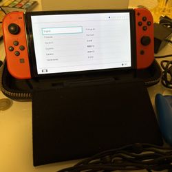 Nintendo Switch OLED w/ Mario Red Joycons And Blue Joycon Grip
