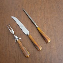 Vintage 40s Universal Resistain 3 Piece Carving Set Butterscotch 
Bakelite Handles.
manufactured in the USA by Landers, Frary & Clark.
The set include
