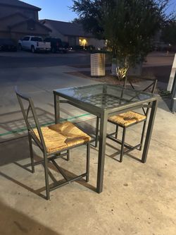 Glass top metal table and 2 chairs