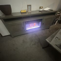 T.V Stand with fire place fits up to 65 -70 inch