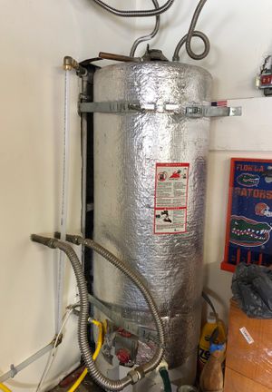 Photo Hot water heater with gas line, exhaust pipe and water lines