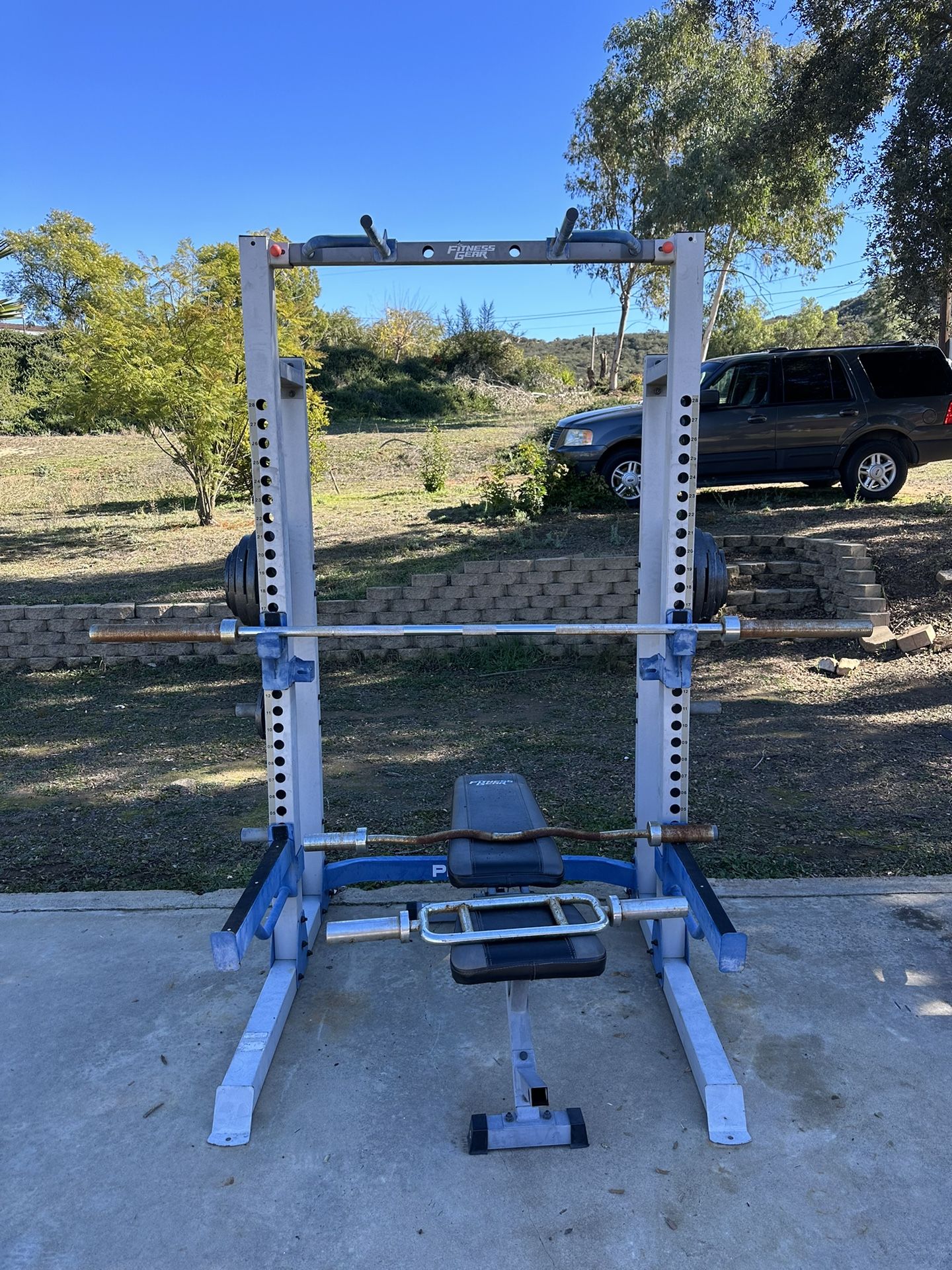 Power Rack With Pull Up Bar, Ez Bar, Hammer Curl Bar, And Olympic Bar With 250 Pounds Of Weight 