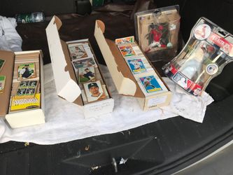 Three boxes of cards and two action figures.