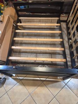 2 bed frame(bunk bed) black and stack together with wooden sticks from IKEA, bottom bed is a full and the top is a twin