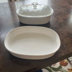 Set of two white ceramic baking dishes with lids.