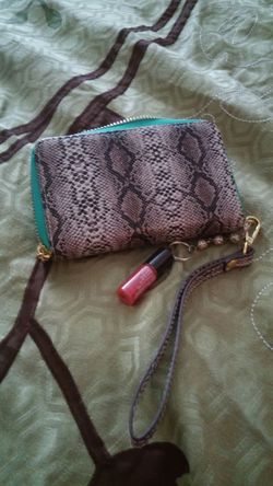 Avons Mark brand snake print wristlet with attached lip gloss