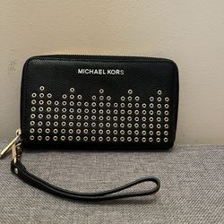 NWT! Black zippered wallet with detachable wrist strap. Inside has 7 card slots, zippered pouch, and slot for cash and ID and more. Measurements 7”wid