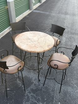 Wrought Iron, Marble Top Table With Four Swivel Bar Stools.