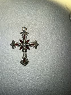 Jeweled bronze-tone cross with red enamel, clear stones, and pearl center