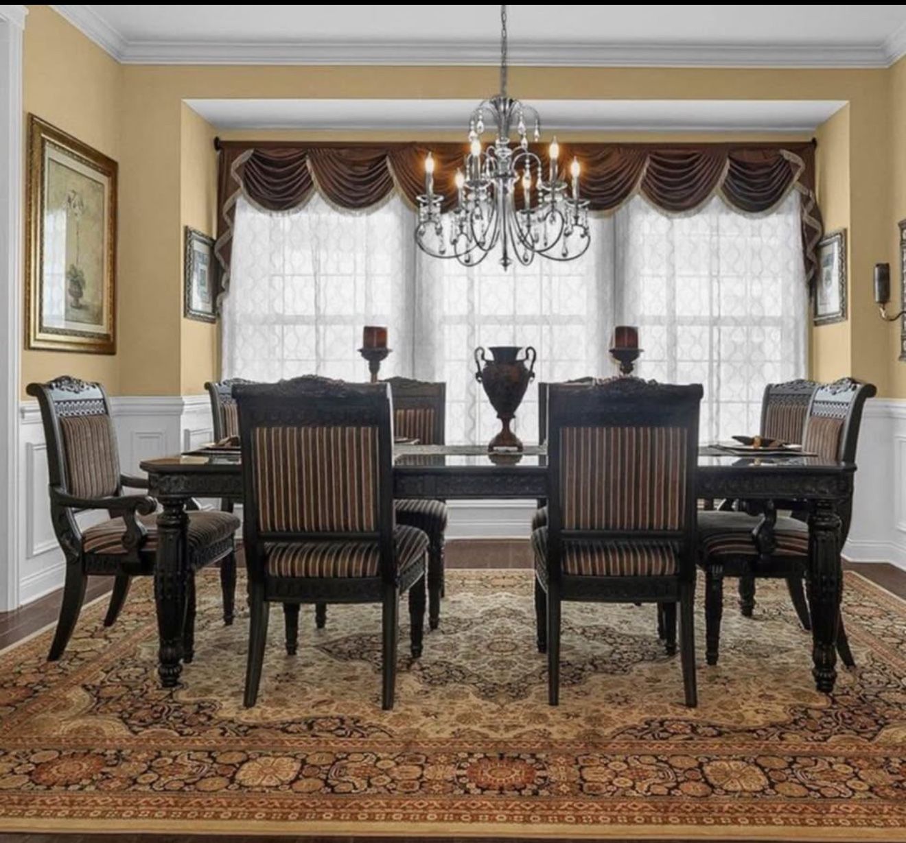 LAST CHANCE MOVING THIS SUNDAY Elegant Dining Table Set with eight chairs, a buffet hutch, and a mirror with ornate wood work