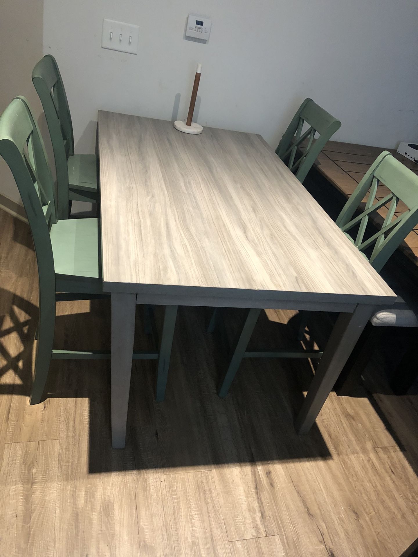 Grey Table With Beautiful Green Chairs