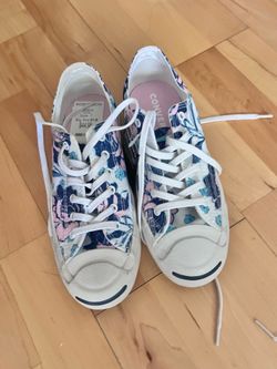 Converse Jack Purcell women's low-top canvas sneakers featuring a white, blue, and pink floral print