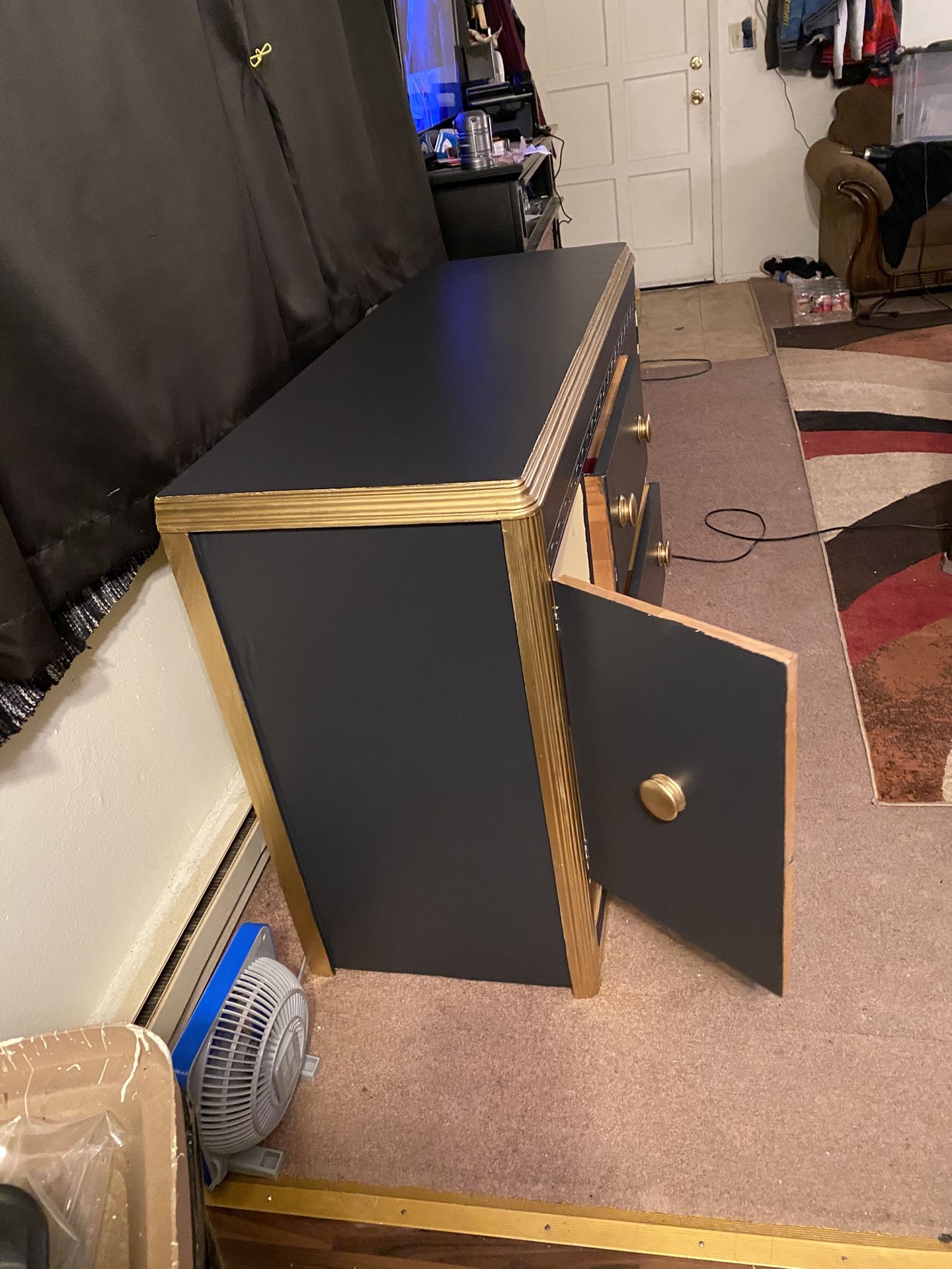 $180- (firm on price)1 Black and gold Vintage dresser! Lots of storage space behind each side door. H-2‘10“ X L 4 ft 4 1/2” X D 1‘7“ Could use a rep