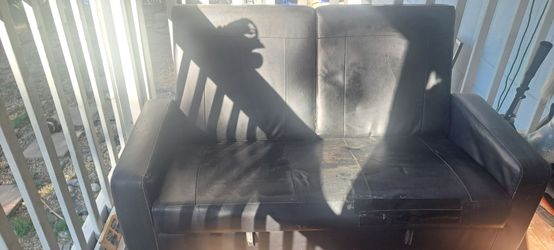 Small black couch with storage space