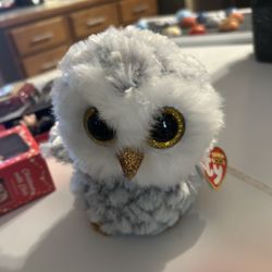 Ty Beanie Boos Owlette Owl plush toy, which is a collectible item.  It features large, sparkly gold glitter eyes, a gold glitter beak, and gold feet. 