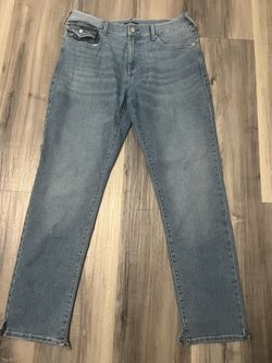 True religion light blue jeans with bootcut rips at the bottom