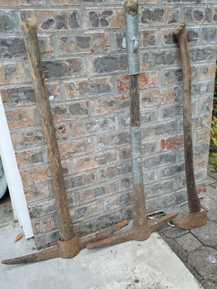 2 antique pick axes and log picker