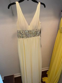 Pale yellow evening gown. V-neck, rhinestone details. New with tags. Size 5