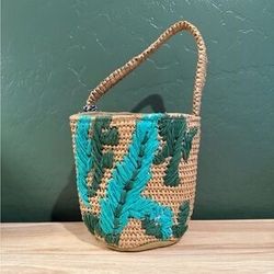 Twig & Arrow woven straw mini tote with a green floral pattern 