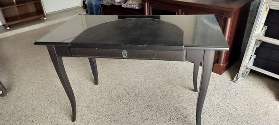Black wooden and glass top desk.