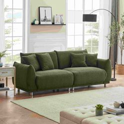 An 86.6 inch teddy wool black sofa with four throw pillows and hardware feet makes it comfortable to sit in an apartment bedroom without taking up spa