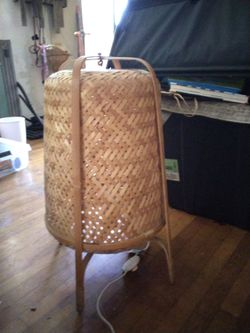 IKEA Knixhult bamboo floor lamp with a hand-woven shade.