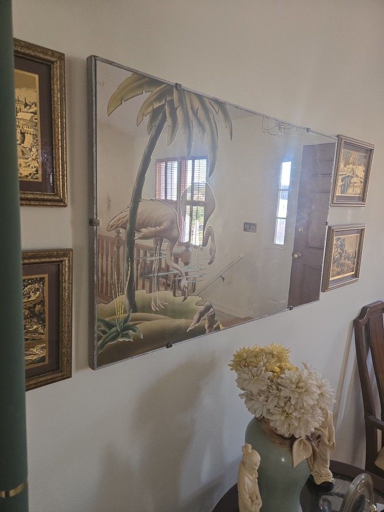 Rectangular wall mirror with etchings.