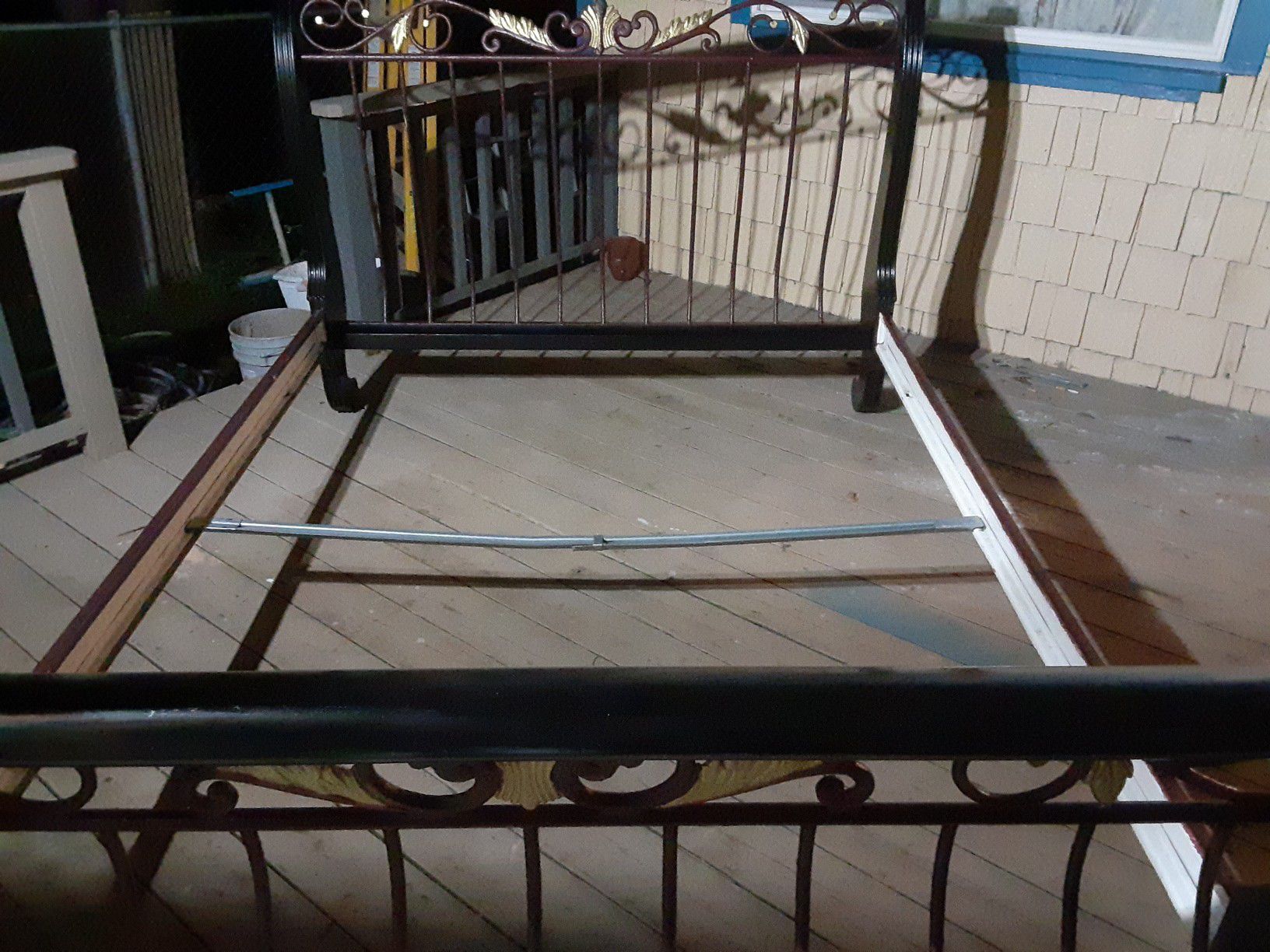 Refined wrought iron and wood sleigh bed