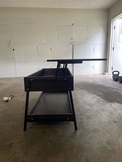 Table with spring assist opening