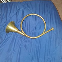 Round brass hunting horn