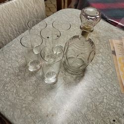 New wine glasses and antique used bottle