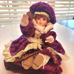 Classic Treasures Animated & Musical Porcelain Doll-burgundy attire