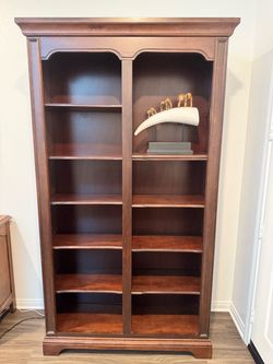 Coffee Colored book cases with adjustable 10 adjustable shelves. Lighted top shelf.